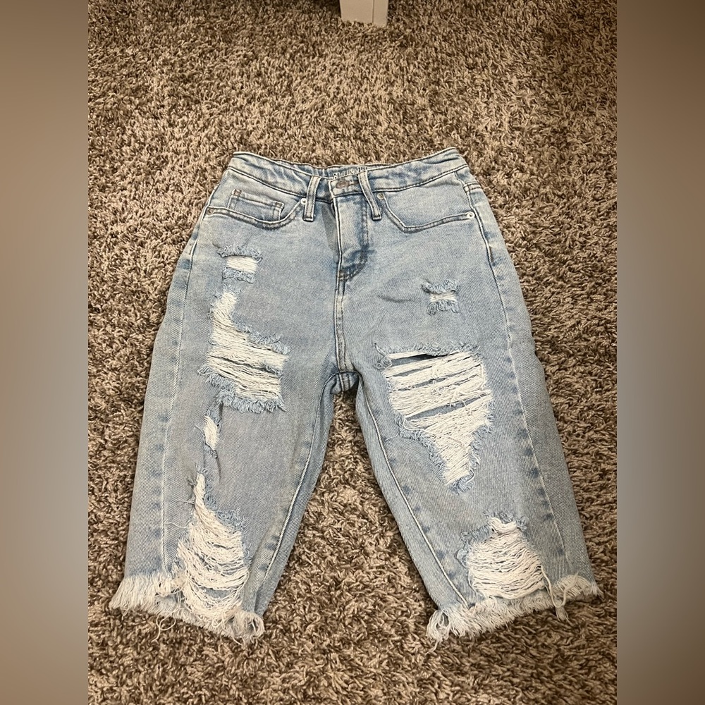 Ripped jeans shorts that stop at the knee